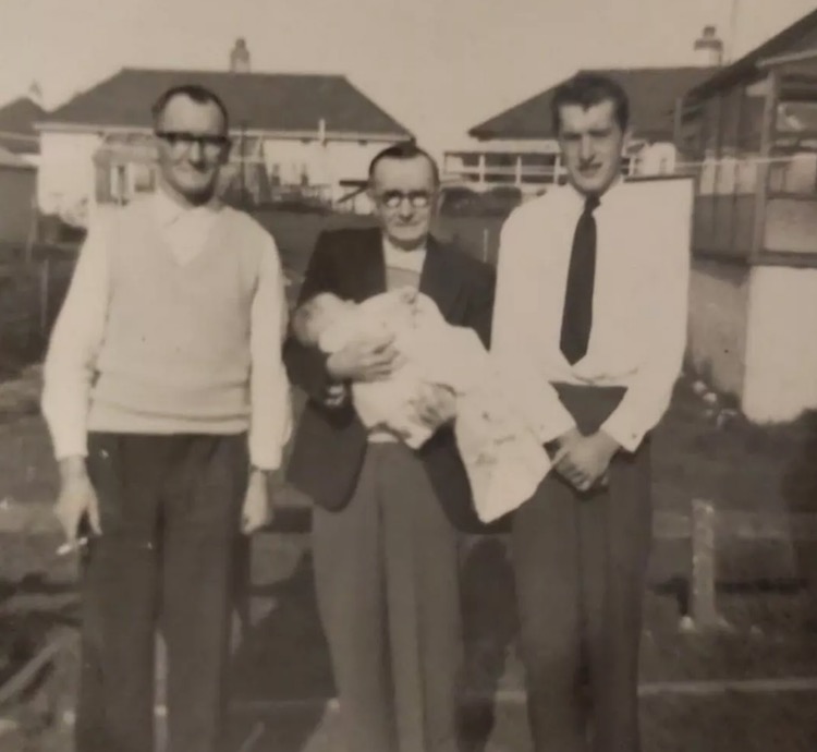 Wilson's father, Andrew Fletcher, as a baby with her grandfather Cyril Fletcher and two other people.